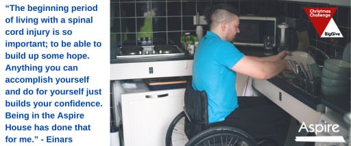 Einars in his wheelchair at a sink washing up 